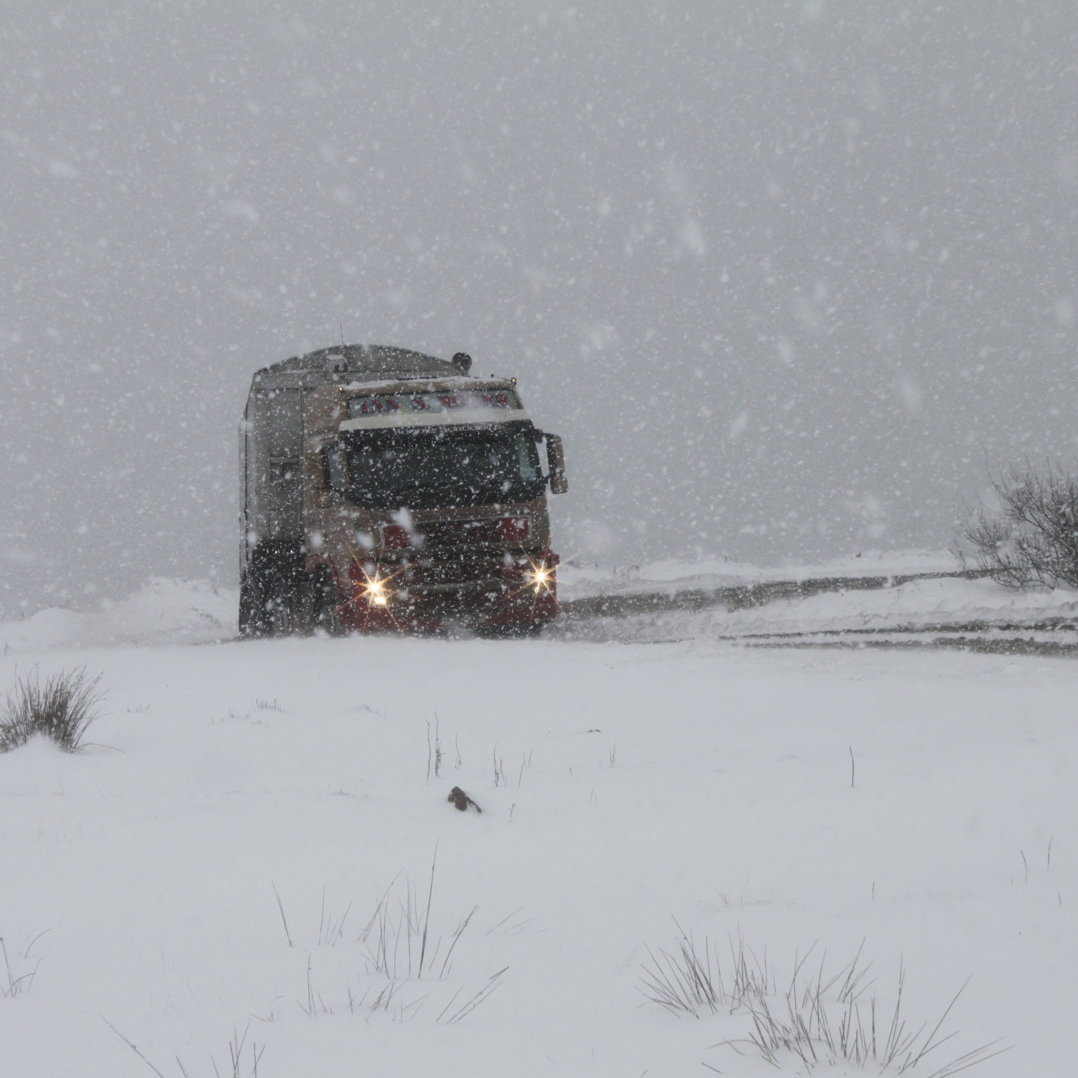 Headlights through the snow by Jez Braithwaite