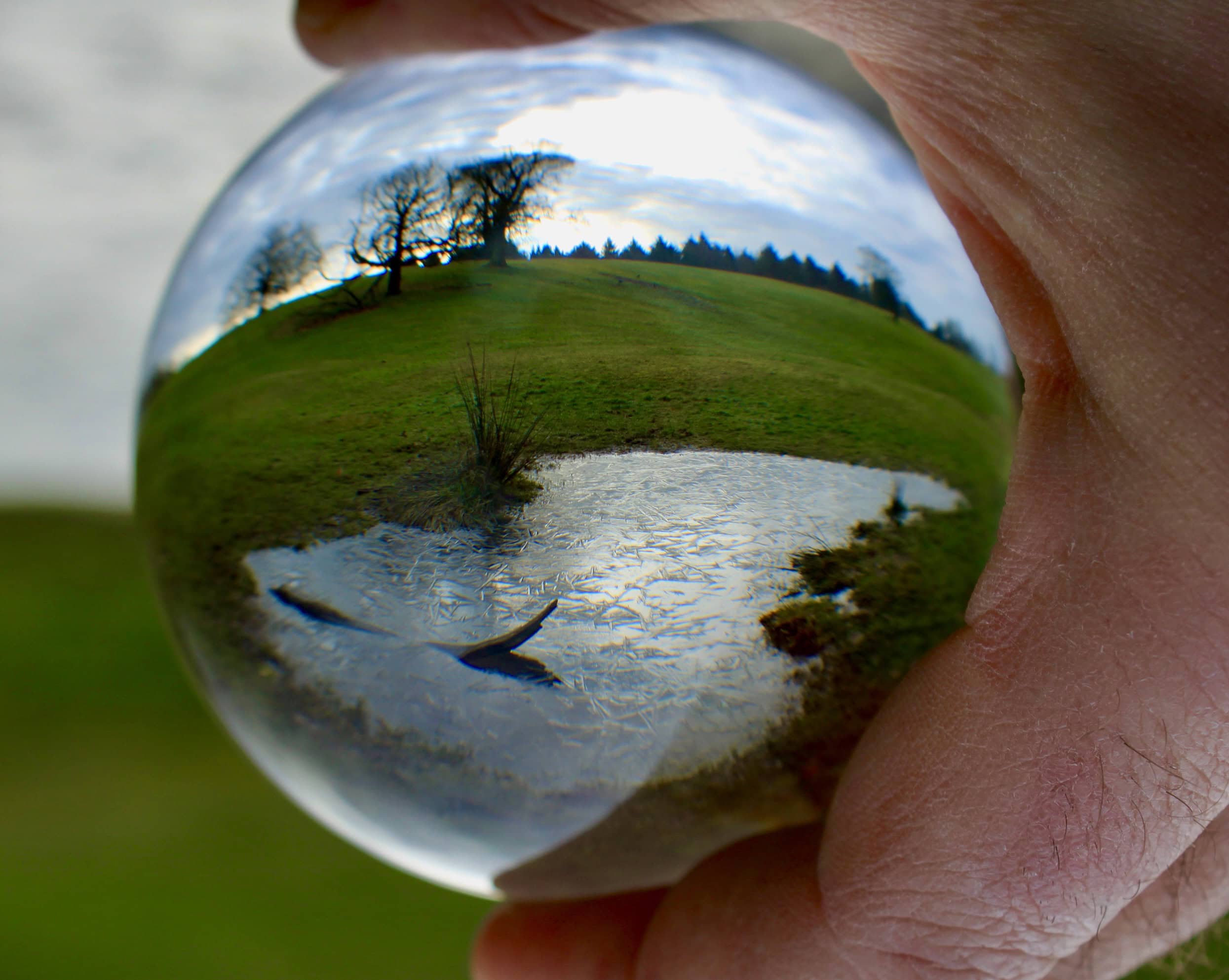 Frozen pond through a lensball
