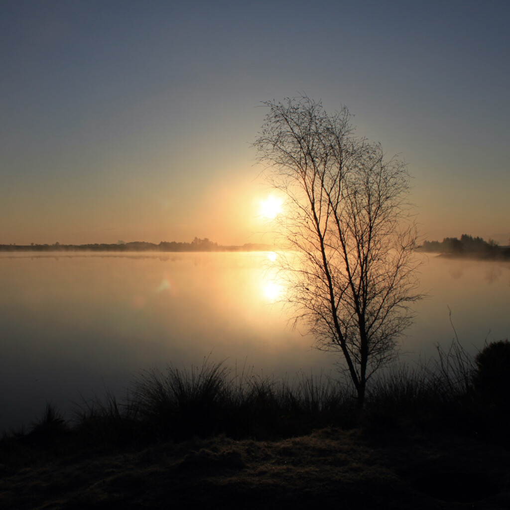 Reflected sunrise over Fannyside Lochs
