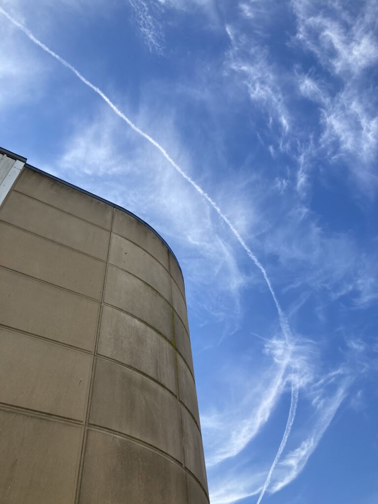 Contrail above building